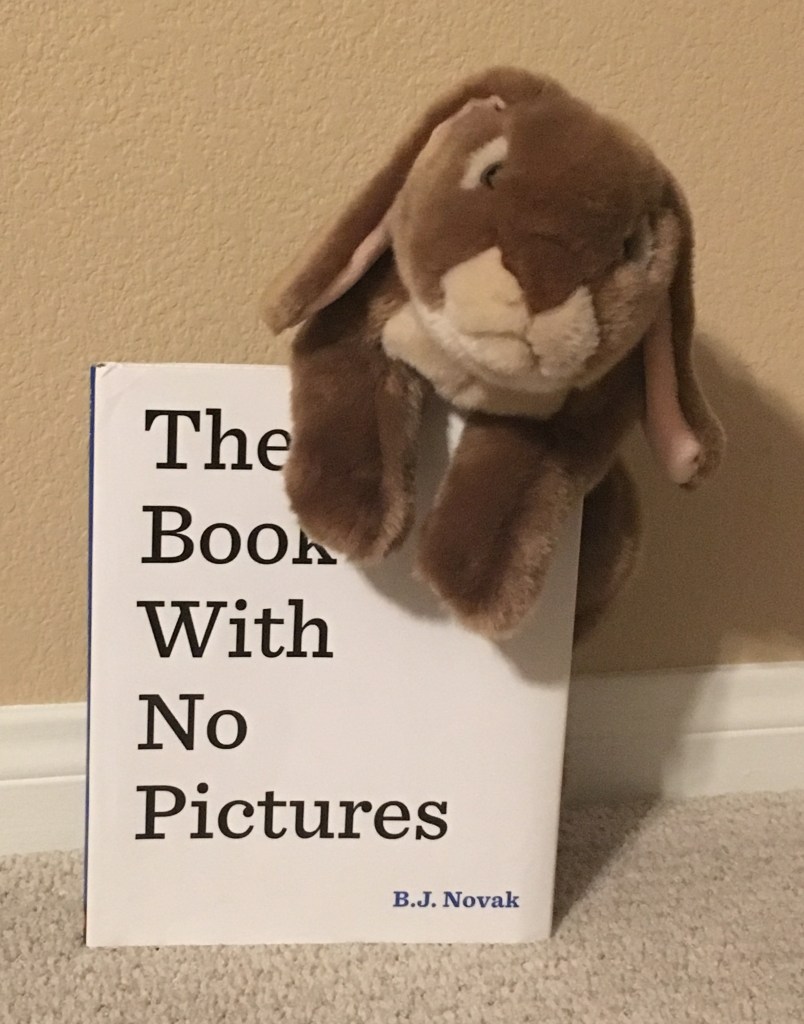 Caramel loves reading and having adults read The Book With No Pictures by B.J. Novak.