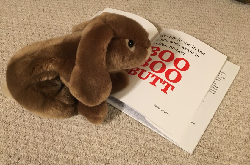 Caramel is rereading one of his favorite pages in The Book With No Pictures by B.J. Novak.