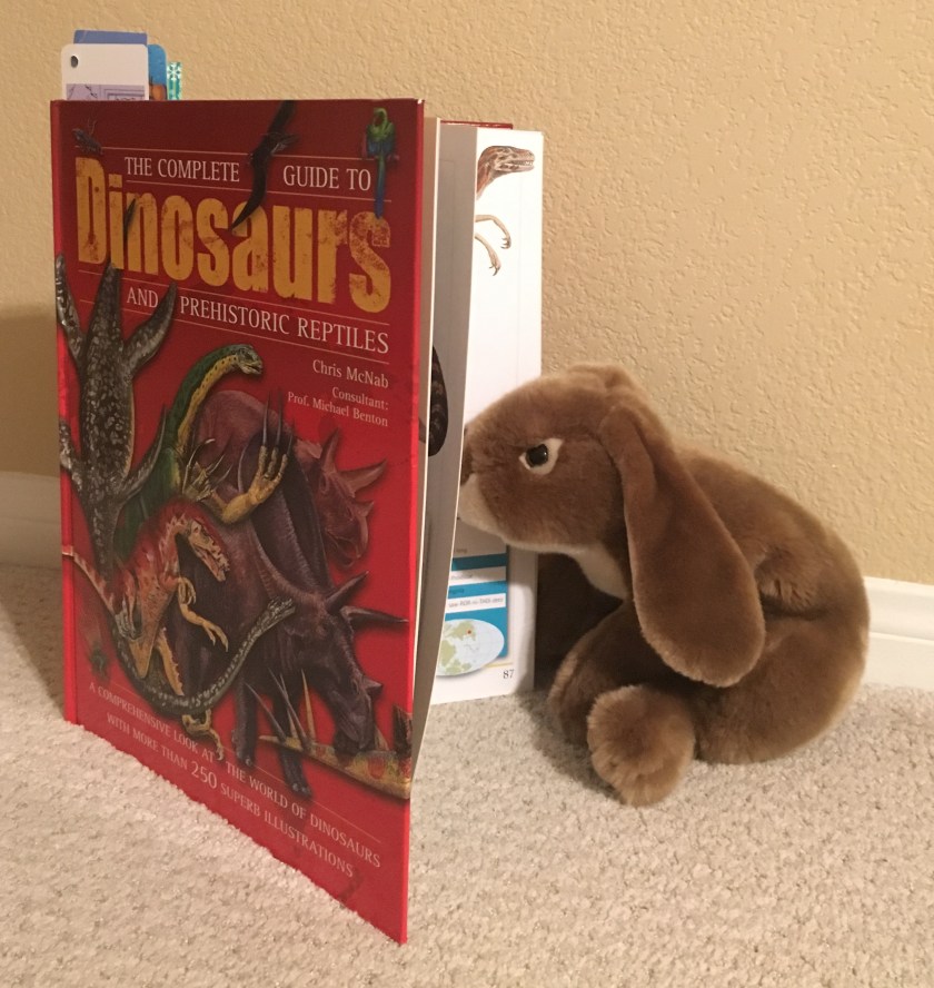 Caramel enjoys reading about dinosaurs in The Complete Guide to Dinosaurs and Prehistoric Reptiles.﻿
