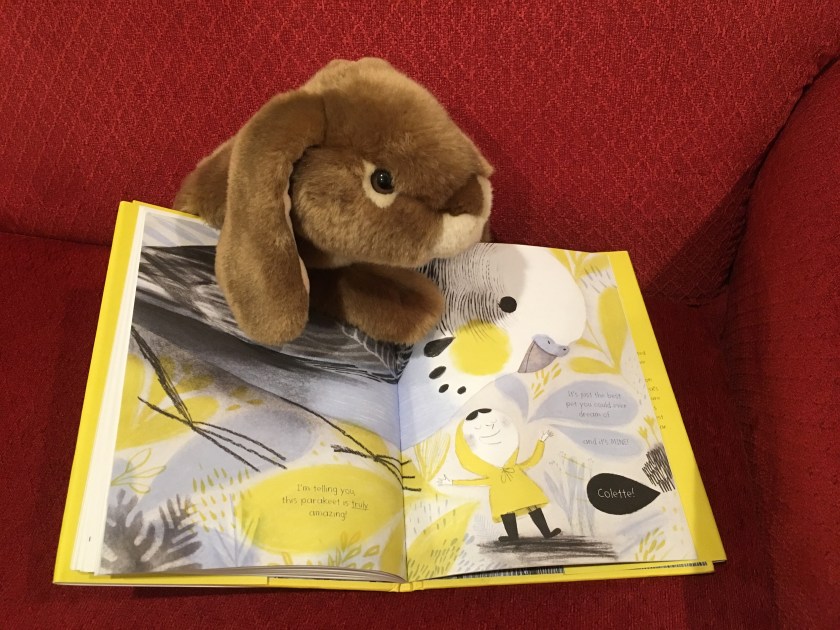 Caramel is pointing at a particularly spectacular page where Colette is telling her elaborate story about her non-existent parakeet. 