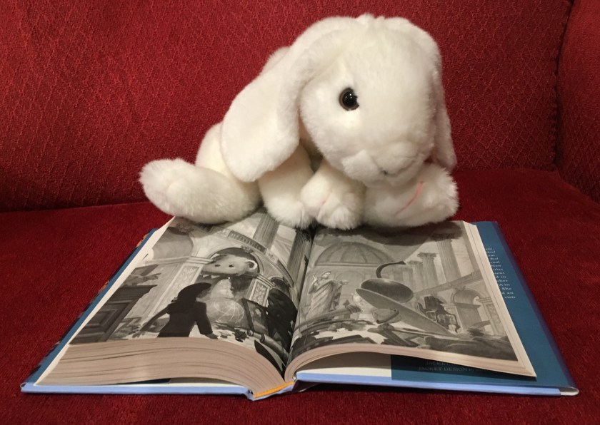 Marshmallow is pointing at a picture from the book, but do not look too carefully if you don't want any further spoilers!