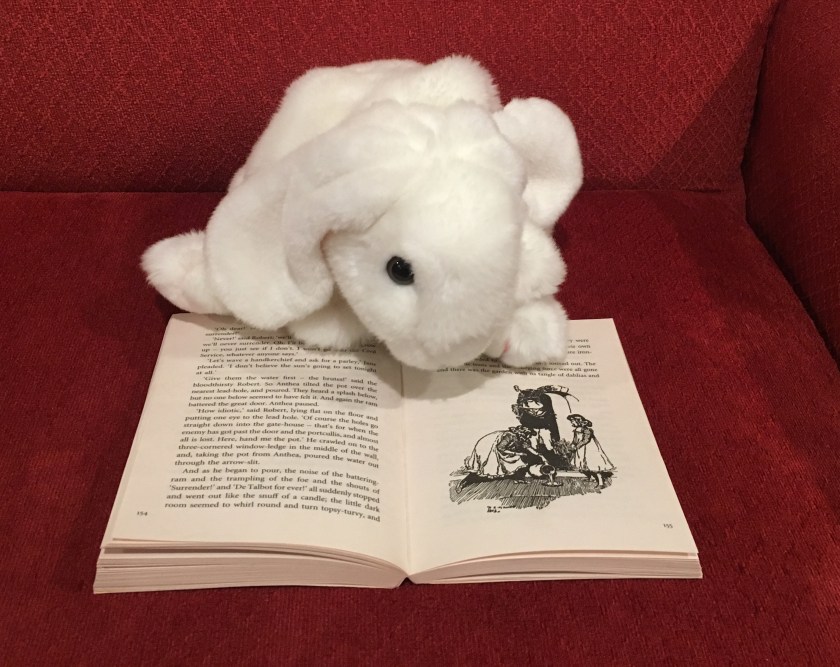 Marshmallow is pointing out one of the many illustrations in Five Children and It by E. Nesbit. 