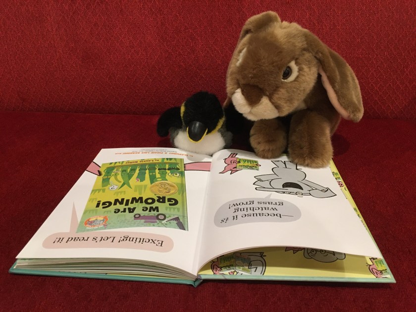 Caramel and his mysterious penguin friend are reading the preamble of We Are Growing! by Laurie Keller, where Elephant and Piggie tell the readers that reading this book is like watching grass grow ... because it is! But in the best possible way... 