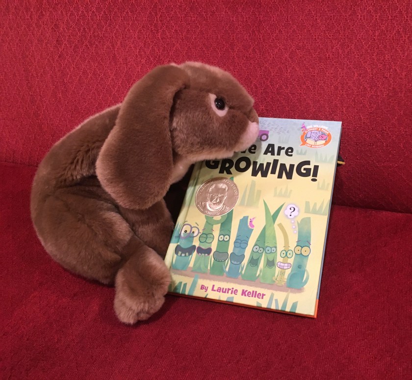 Caramel reviews We Are Growing! by Laurie Keller. (Can you see the little beak behind the book? Who is hiding there??)