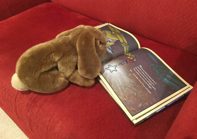 Caramel is reading Goodnight, Goodnight, Construction Site, written by Sherri Duskey and illustrated by Tom Lichtenheld.