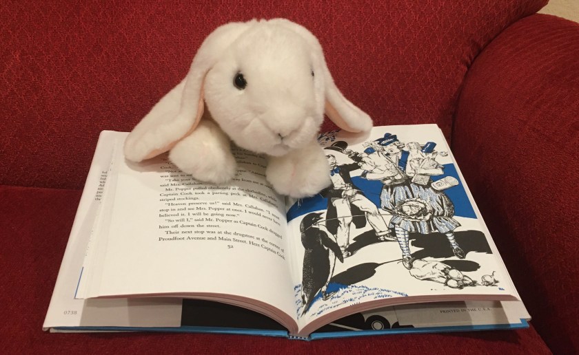 Marshmallow is pointing at one of the illustrations in Mr. Popper's :Penguins, written by Richard and Florence Atwater. The illustrations were made by Robert Lawson.