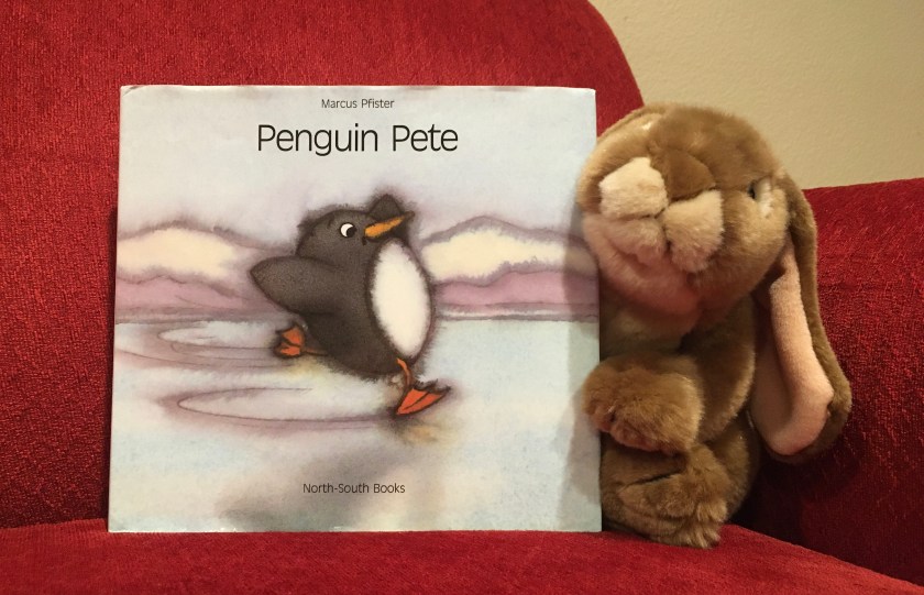 Caramel enjoys reading and rereading Penguin Pete by Marcus Pfister. 