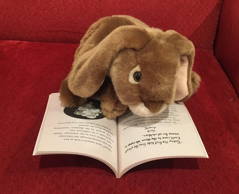 Caramel is reading Midnight on the Moon (Magic Tree House #8) by Mary Pope Osborne.