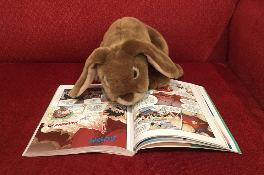 Caramel is reading Survive: The Digestive System, illustrated by Hyun-Dong Han.