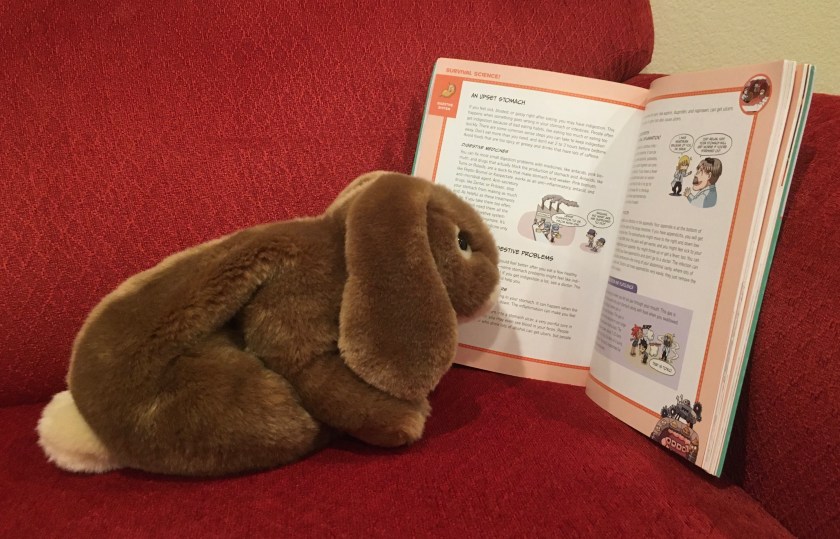 Caramel is reading one of the fact based spreads in Survive: The Digestive System, illustrated by Hyun-Dong Han.