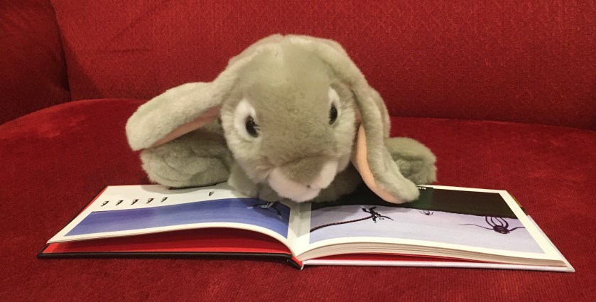 Sprinkles is reading Zombies Hate Stuff by Greg Stone; apparently zombies hate giant purple monsters and penguins. 