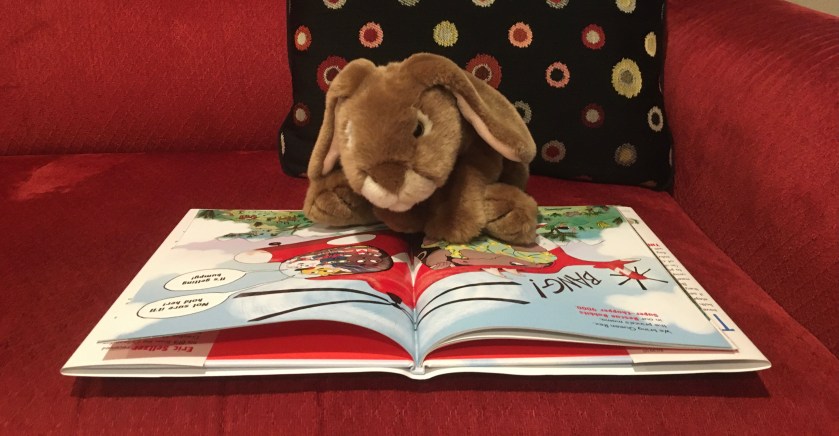 Caramel is reading The Rescue Rabbits written by Eric Seltzer and illustrated by Roland Garrigue. On this page there is a rhino queen, Queen Rex, and she is a bit too big for the helicopter the Rescue Rabbits are riding.