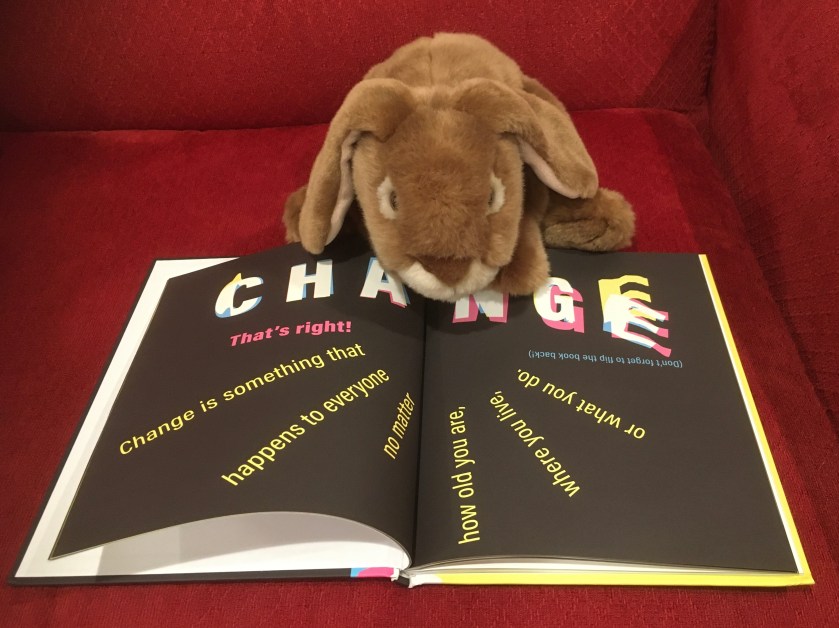 Caramel is reading A Kids Book About Change by David Kim. 