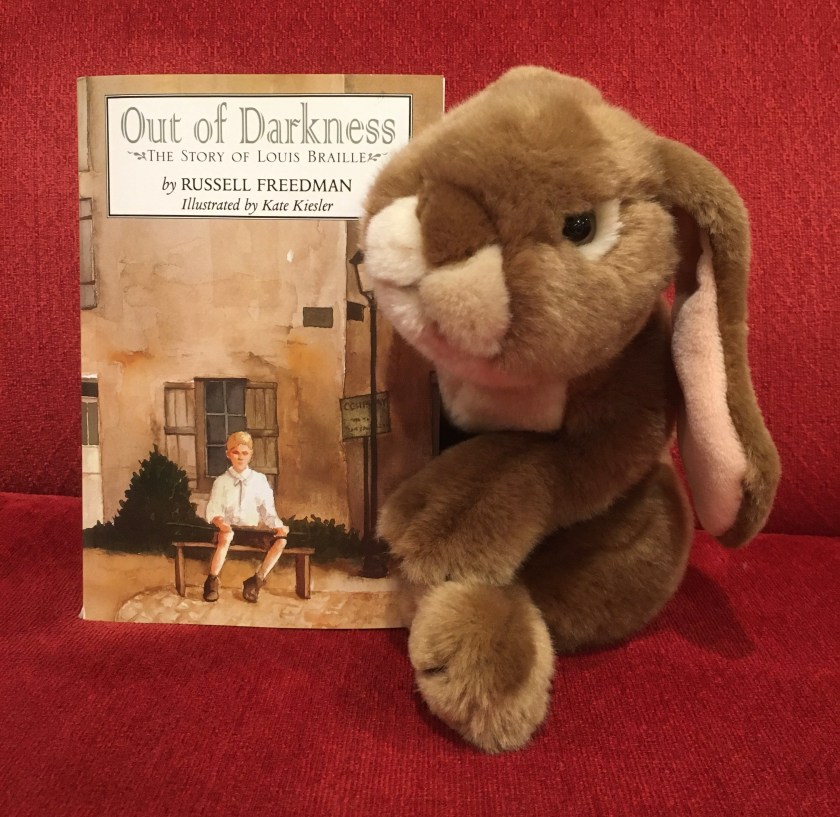 Caramel reviews Out of Darkness: The Story of Louis Braille, written by Russell Freedman and illustrated by Kate Kiesler.