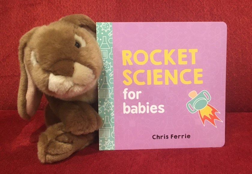 Caramel is posing with Rocket Science for Babies by Chris Ferrie, his favorite so far in this series. 