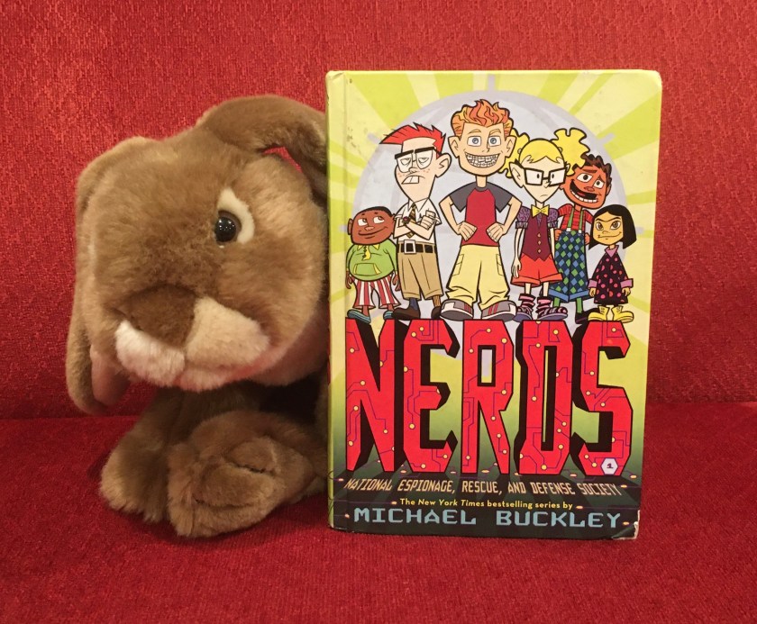 Caramel reviews N.E.R.D.S.: National Espionage, Rescue, and Defense Society, by Michael Buckley.