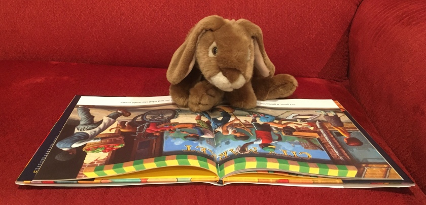 Caramel is reading Change Sings: A Children's Anthem, written by poet Amanda Gorman and illustrated by Loren Long.