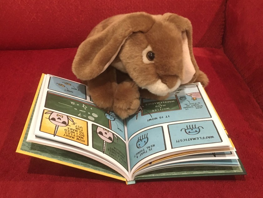 Caramel is reading Narwhal's School of Awesomeness by Ben Clanton.