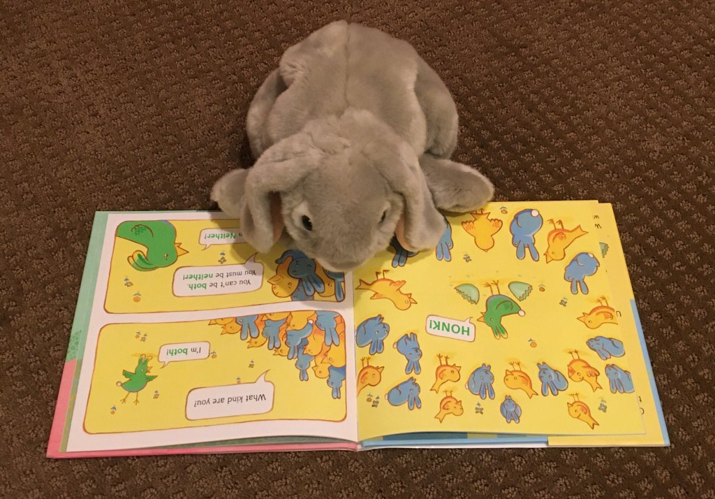 Sprinkles is reading Neither by Airlie Anderson.