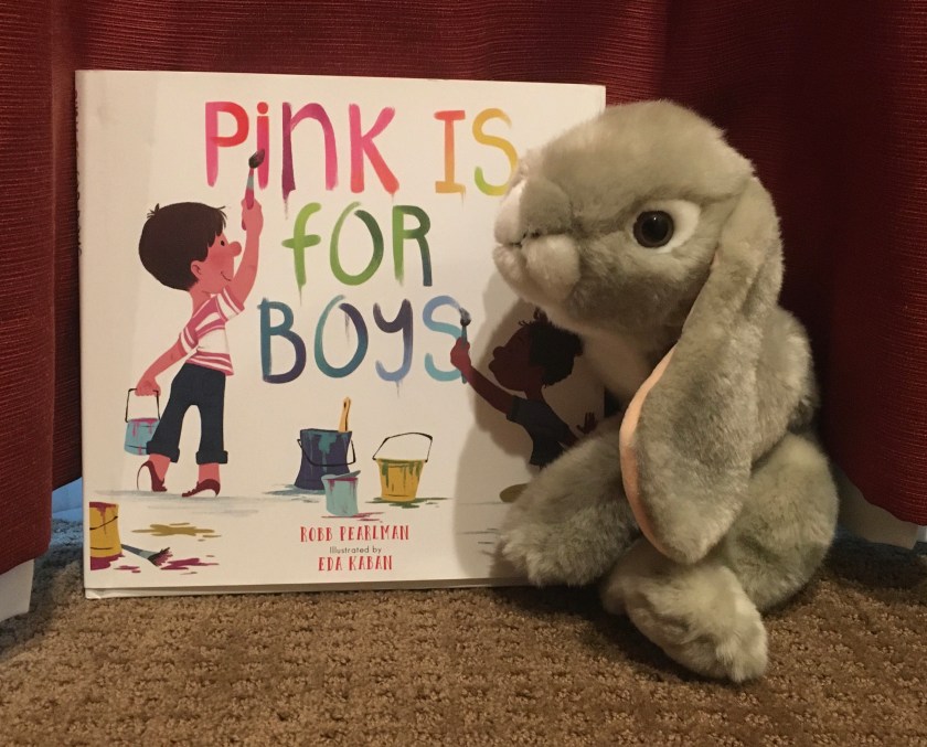 Sprinkles poses with Pink Is For Boys, written by Robb Pearlman and illustrated by Eda Kaban. 