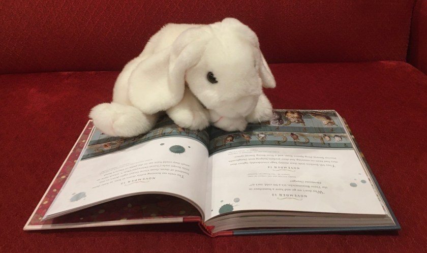 Marshmallow is reading the entry for today, November 13, in Harry Potter: A Magical Year - The Illustrations of Jim Kay by J.K. Rowling and Jim Kay. The entry is a quote from Hermione Granger, taken from Chapter 19 of Harry Potter and the Goblet of Fire: "Why don't we go and have a butterbeer in the Three Broomsticks, it's a bit cold, isn't it?"