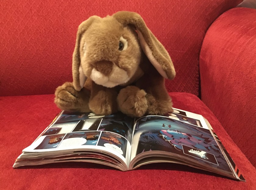 Caramel is reading Cleopatra in Space: The Golden Lion by Mike Maihack.