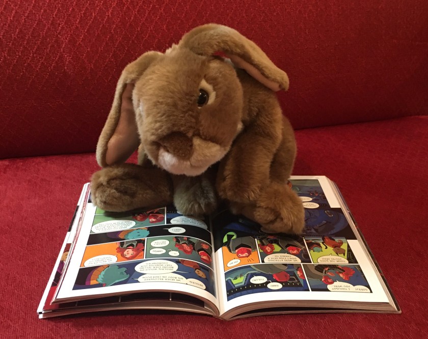 Caramel is reading Cleopatra in Space: Queen of the Nile by Mike Maihack.