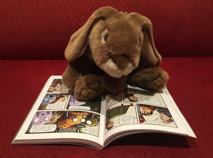 Caramel is reading The Aquanaut by Dan Santat.