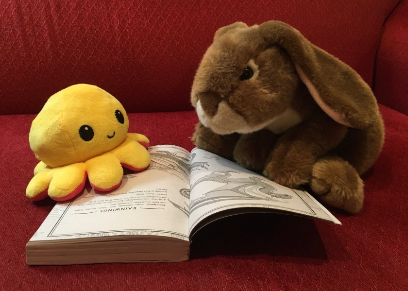 Caramel and his happy friend are discussing the various types of dragons in Escaping Peril (Book Eight of the Wings of Fire series) by Tui Sutherland.