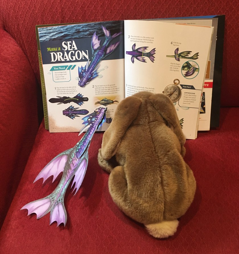 Caramel and his new friend Sea Dragon are reading about other sea dragons in Paper Flying Dragons by Pat Murphy.