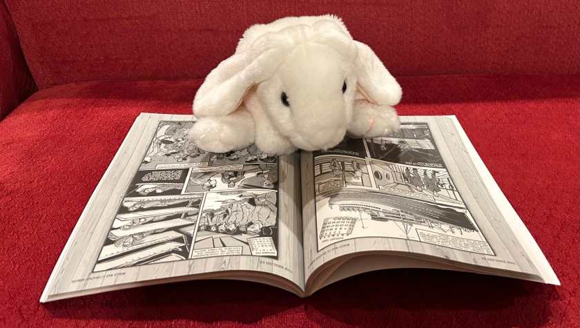 Marshmallow is reading The English GI: World War II Graphic Memoir of A Yorkshire Schoolboy's Adventures in the United States and Europe, written by Jonathan Sandler and illustrated by Brian Bicknell.