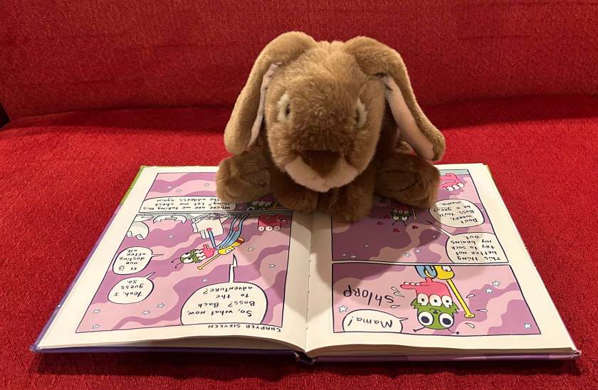 Caramel is reading The Glorkian Warrior Delivers Pizza by James Kochalka.