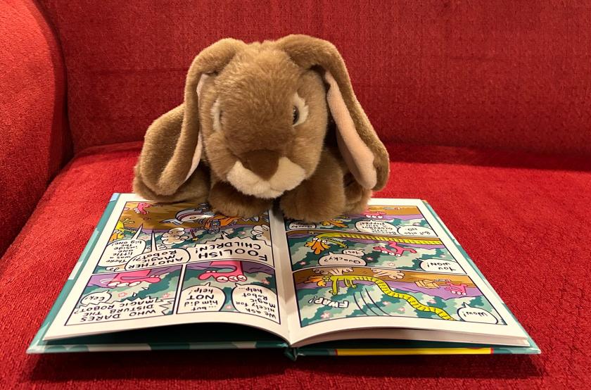 Caramel is reading Glork Patrol and the Magic Robot by James Kochalka. 