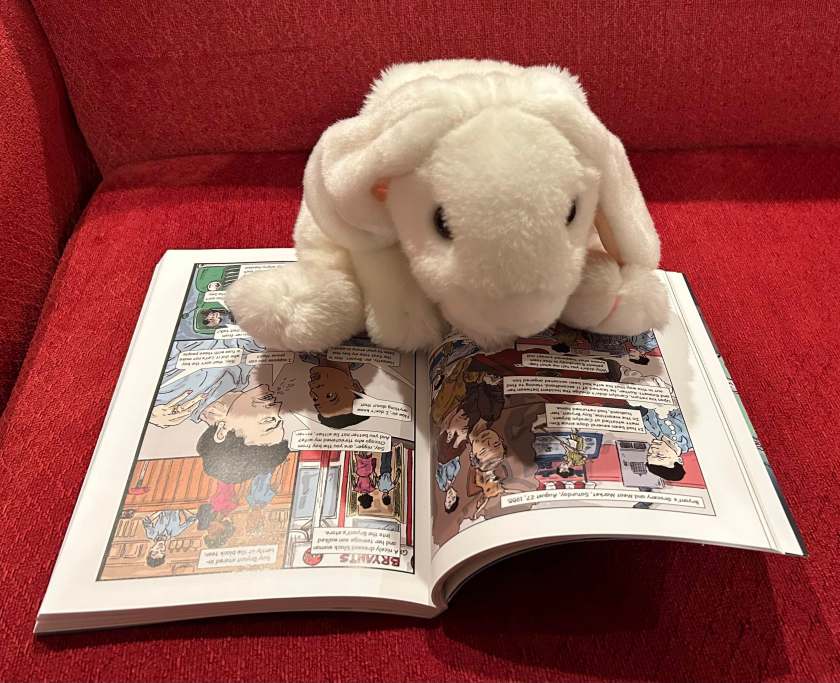 Marshmallow is reading The Murder of Emmett Till by Karlos K. Hill and David Dodson.