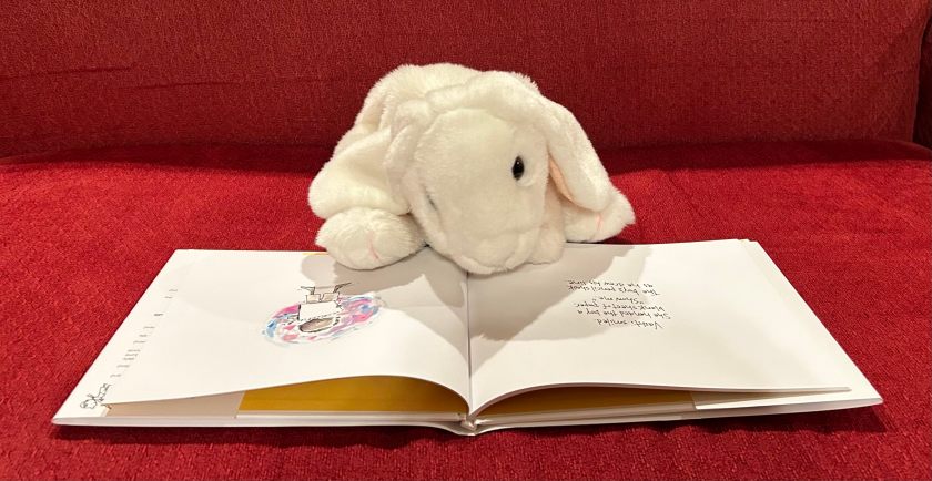 Marshmallow is reading The Dot by Peter H. Reynolds. 
