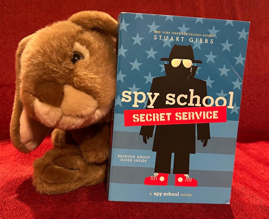 Caramel loved reading Spy School: Secret Service by Stuart Gibbs and is ready for the next book.