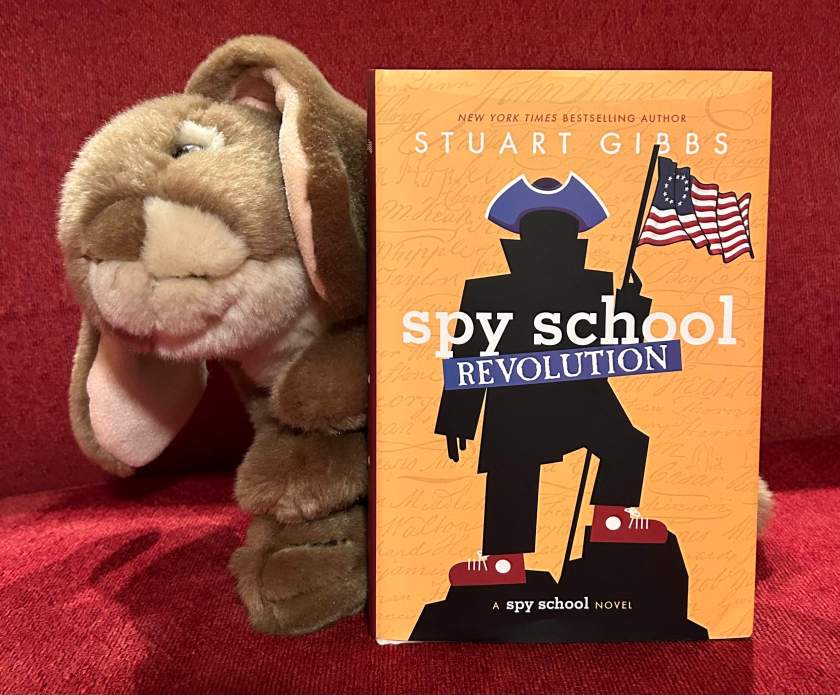 Caramel loved reading Spy School Revolution by Stuart Gibbs and is ready for book nine.