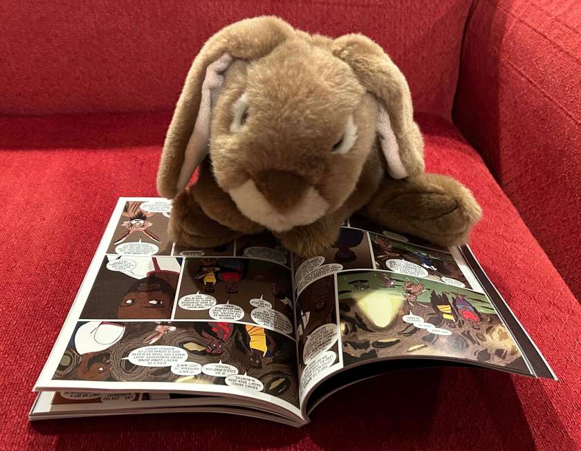 Caramel is reading Tristan Strong Punches a Hole in the Sky: The Graphic Novel, written by Kwame Mbalia, adapted by Robert Venditti, and illustrated by Olivia Stephens.