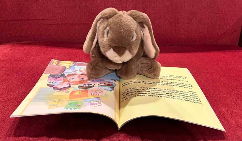 Caramel is reading My Friend John by Arleen McCarthy.