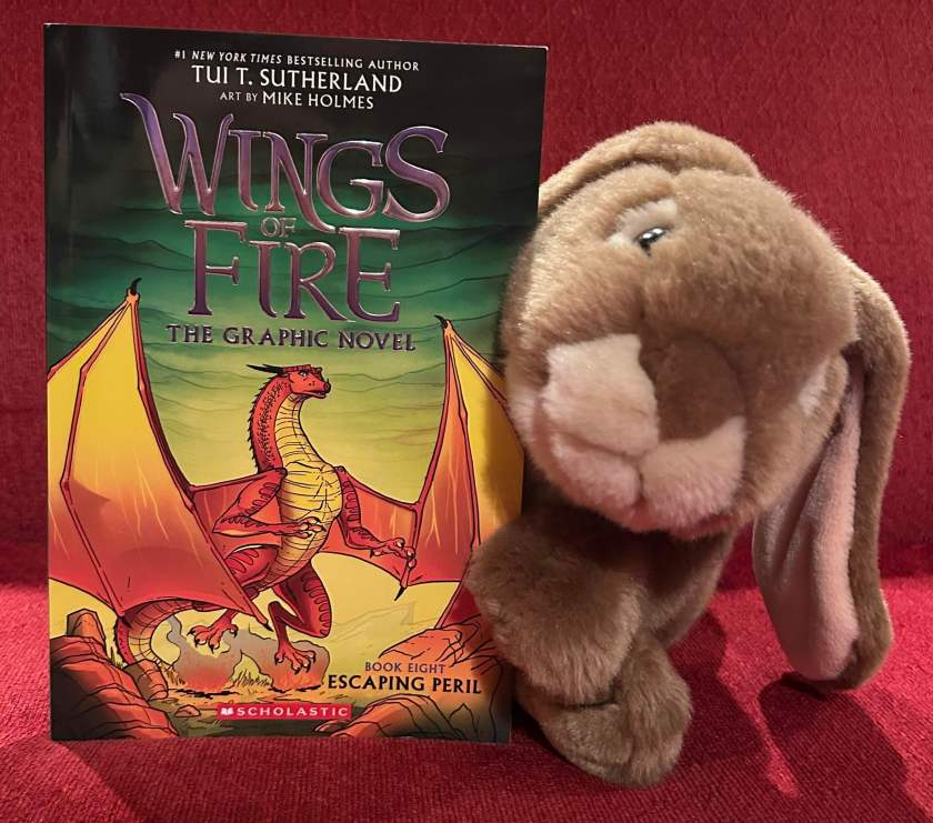 Caramel is excited to have read Escaping Peril: The Graphic Novel (Book Eight of Wings of Fire), written by Tui Sutherland and illustrated by Mike Holmes, and looks forward to rereading it many more times in the coming weeks and months. 
