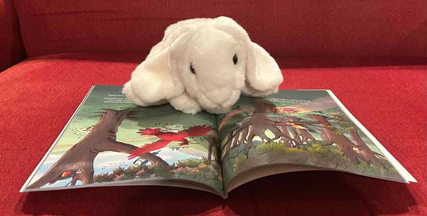 Marshmallow is reading There's A Hair In My Dirt! A Worm's Story by Gary Larson.