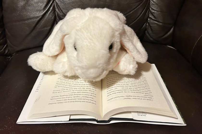 Marshmallow is reading Powerful by Lauren Roberts.