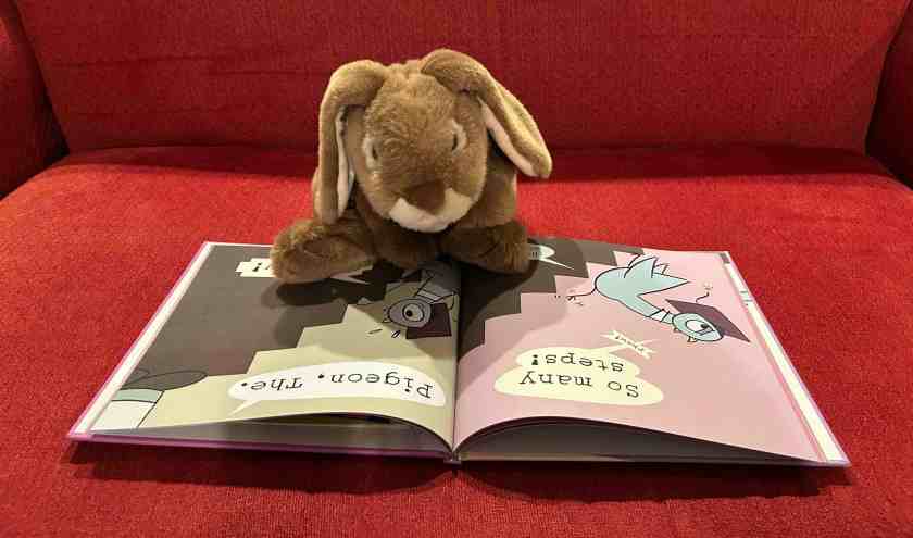 Caramel is reading Will the Pigeon Graduate? by Mo Willems.