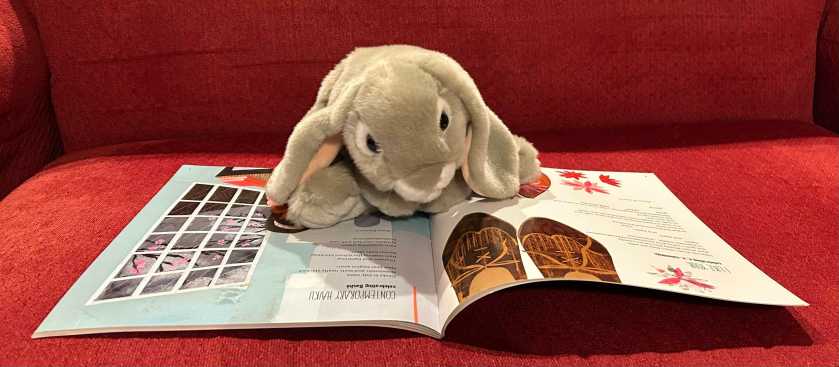 Sprinkles is reading Out Of Wonder: Celebrating Poets and Poetry by Kwame Alexander, Chris Colderley, and Marjory Wentworth.