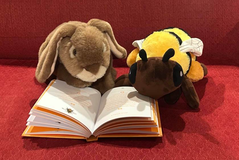 Caramel and Bee-positive the Bee are reading The Little Book of Bees: Buzzy Wit and Wisdom by Sandra Lawrence.