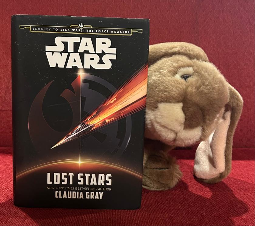 Caramel enjoyed reading Star Wars: Lost Stars by Claudia Gray and is now looking through a whole pile of other Star Wars books to pick the one to read next.