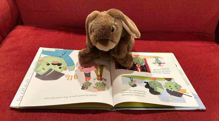 Caramel is reading Zombie and Brain Are Friends, written by Stephanie V.W. Lucianovic and illustrated by Laan Cham.