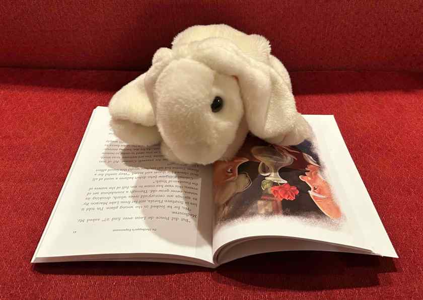 Marshmallow is reading Spooky Classics for Children: A Companion Reader, as told by Jim Weiss, and with Dramatizations by Chris Bauer