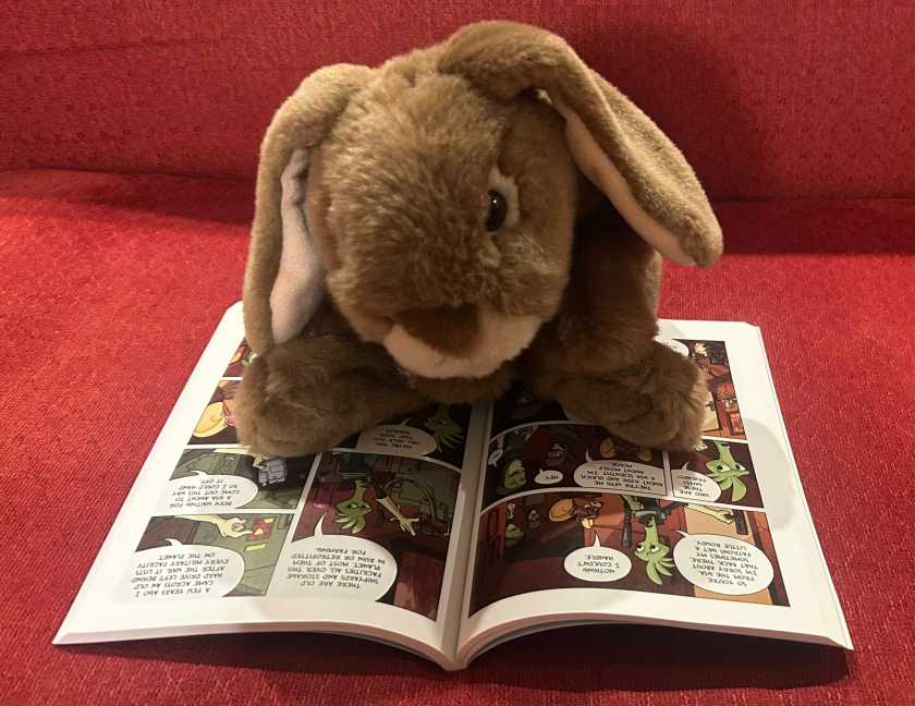 Caramel is reading Missile Mouse: The Star Crusher by Jake Parker.