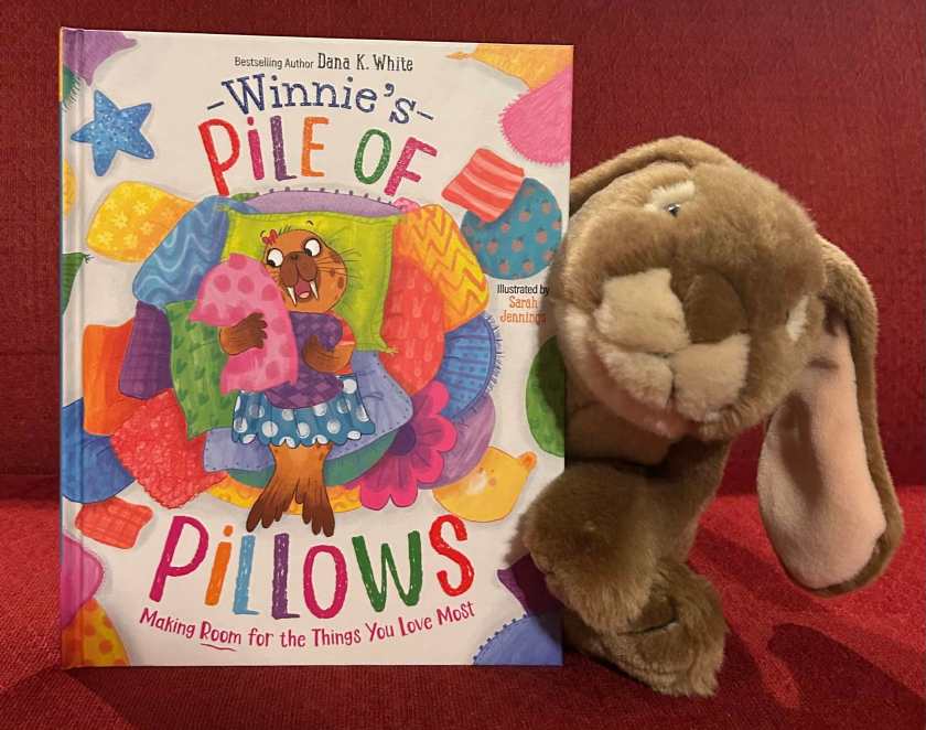 Caramel enjoyed reading Winnie's Pile of Pillows: Making Room for the Things You Love Most, written by Dana K. White and illustrated by Sarah Jennings and finding out that all walruses have tusks and other people love pillows too. 